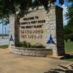 stone entrance sign with military unit emblems