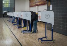 Student IDs No Longer COUNT at 1 State’s Polls Voters at polling booths in a gymnasium
