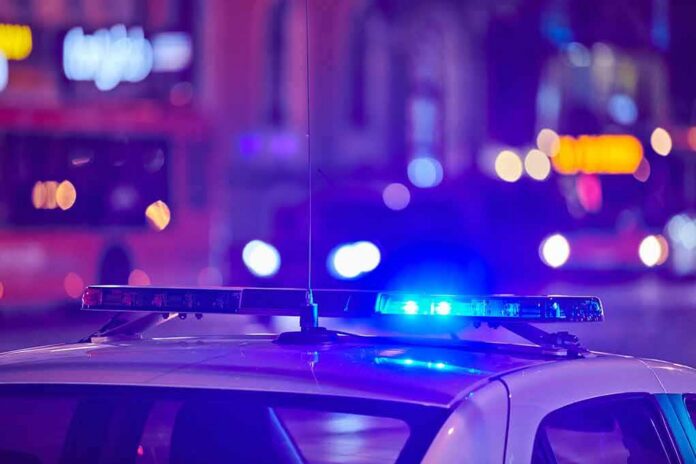 police car roof with flashing blue lights at night