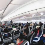 Woman’s Mid-Flight SEXUAL Act Caught on Camera Airplane cabin with passengers seated in economy class
