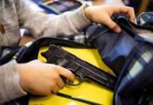 School Shooting’s ARMED Hero Gets Snubbed hand reaches into backpack with a handgun inside