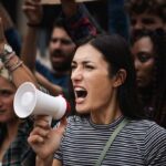 Woman with megaphone shouting at a protest