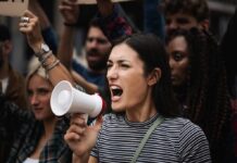 Woman with megaphone shouting at a protest