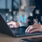 IMF Chief Issues GRIM Warning About AI Hands typing on laptop with AI and tech icons overlay