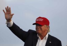 Bush-Bashing Singer Now Goes After TRUMP Donald Trump waving in a red cap