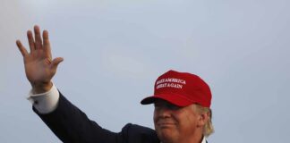 Bush-Bashing Singer Now Goes After TRUMP Donald Trump waving in a red cap