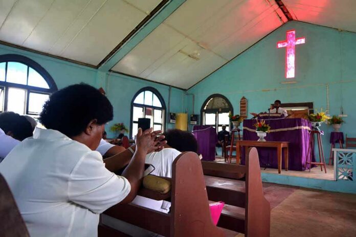 Congregation inside a church with a speaker at the pulpit