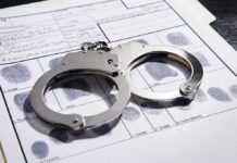 Convicted KILLER Wants $1M From Taxpayers Handcuffs on a fingerprint record form