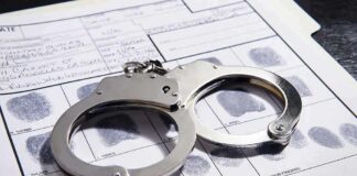 Convicted KILLER Wants $1M From Taxpayers Handcuffs on a fingerprint record form